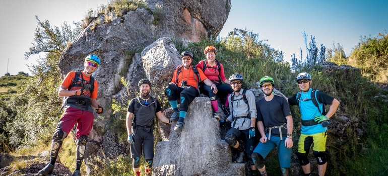 Mountain bikers enjoying an adventure in the Andes of Peru, surrounded by impressive rock formations and mountain scenery.